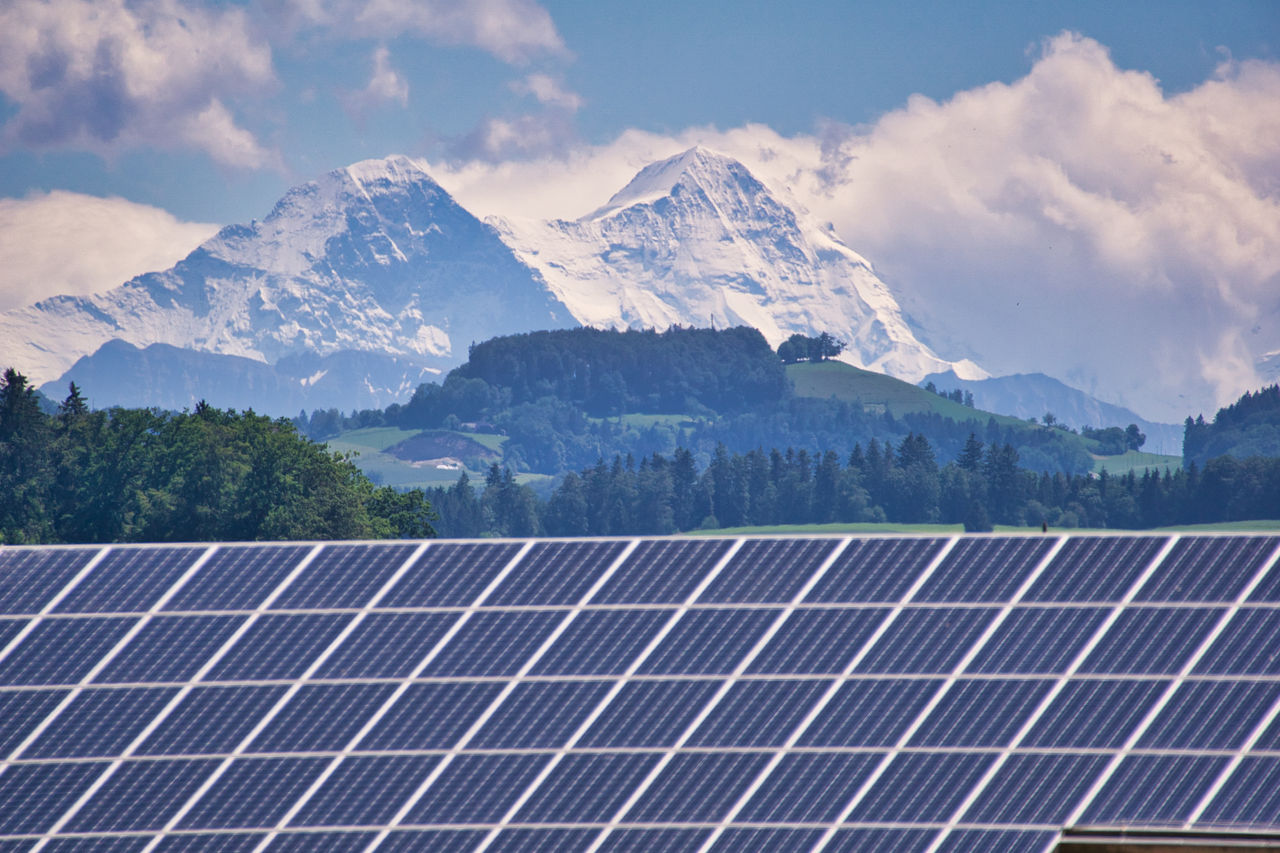 Solarzellen im alpinen Raum vor verschneiten Bergen