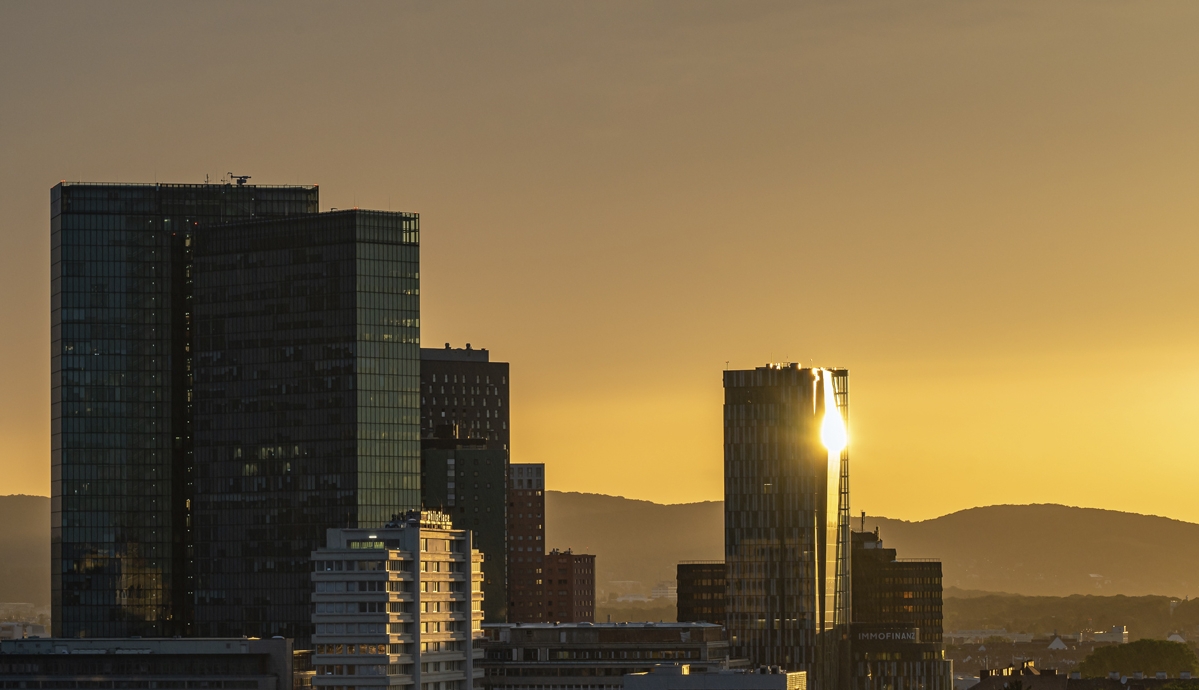 Vienna, Austria July 04 2022 - Vienna Twin Towers and other office buildings in Wienerberg City with reflections from the sunset